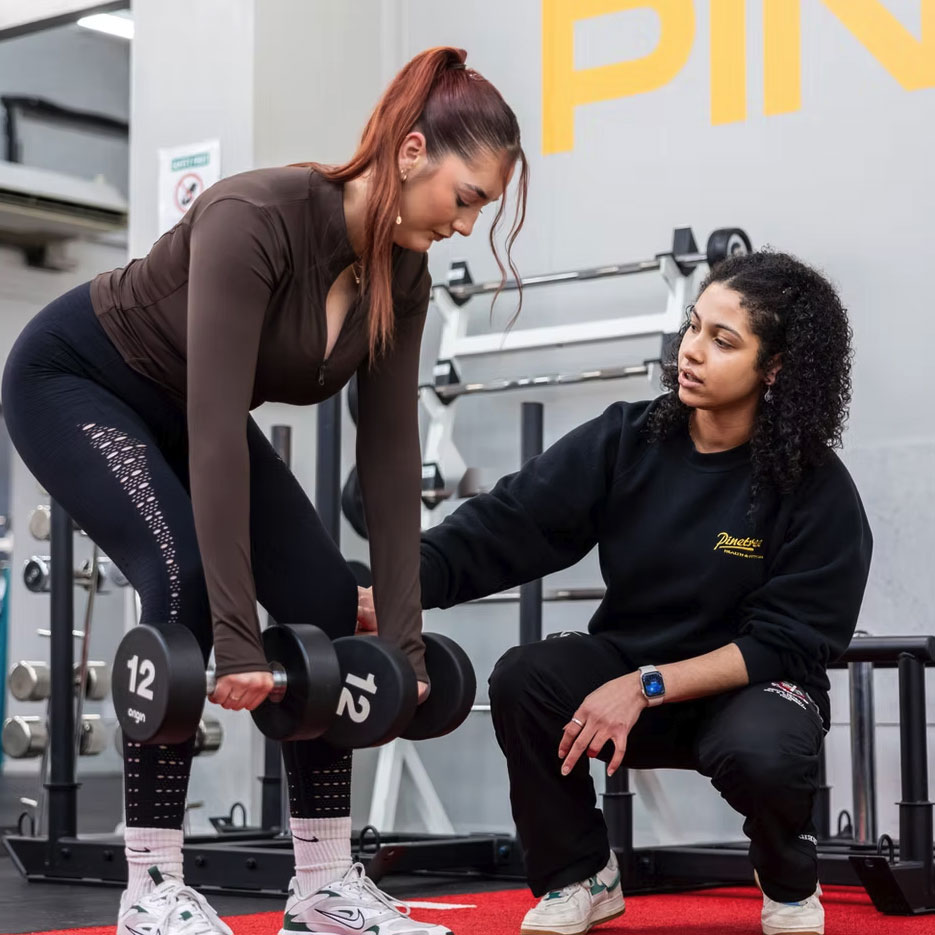 Woman working out with personal trainer